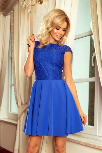 The woman in the photo is wearing a stylish mint green dress, perfect for both casual and formal occasions. The dress features a comfortable fit and elegant design, making it a versatile addition to any wardrobe.