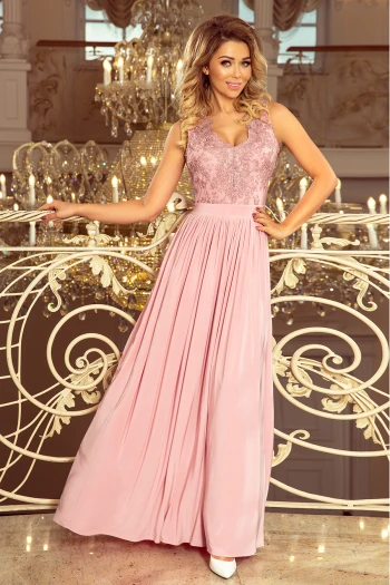 The woman in the photo is wearing a chic, long-sleeved black dress with a flattering V-neckline. The elegant black dress features a flowing silhouette, perfect for any occasion.