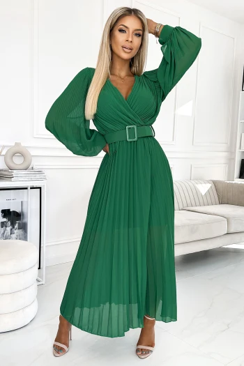 The woman in the photo is wearing a vibrant abstract print dress, featuring a flattering wrap design and a stylish belt. This colorful dress showcases a perfect blend of comfort and elegance, ideal for making a bold fashion statement.