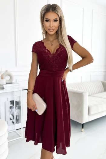 The woman in the photo is wearing a floral print dress, showcasing its elegant design and vibrant colors. This stylish floral dress is perfect for adding a touch of sophistication to any wardrobe.