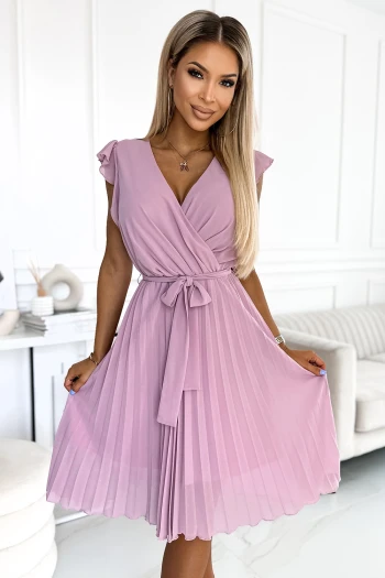The woman in the photo is wearing a stylish striped dress, perfect for casual outings. This striped dress showcases a flattering fit that highlights modern elegance.