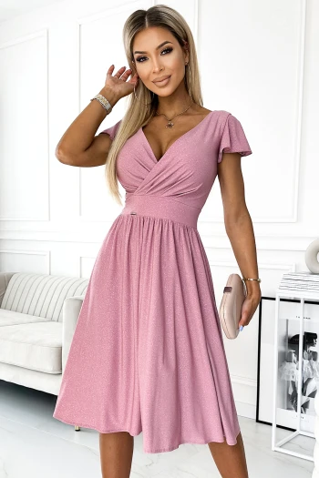 The woman in the photo is wearing a stunning white lace dress, perfect for elegant occasions. The dress features intricate lace detailing and a flattering silhouette, making it a standout piece.