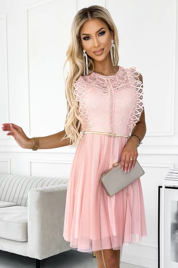 The woman in the photo is wearing a vibrant blue floral maxi dress, showcasing its elegant pleats and intricate floral patterns. This stunning floral maxi dress adds a touch of sophistication and charm to any occasion.