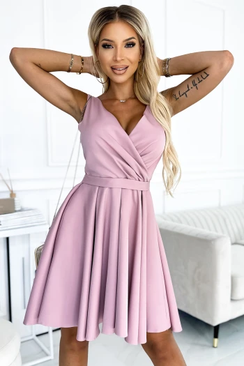 The woman in the photo is wearing a stunning blue shimmer dress, perfect for elegant occasions. This chic dress features a relaxed fit and subtle sparkle, making it a standout piece for any wardrobe.