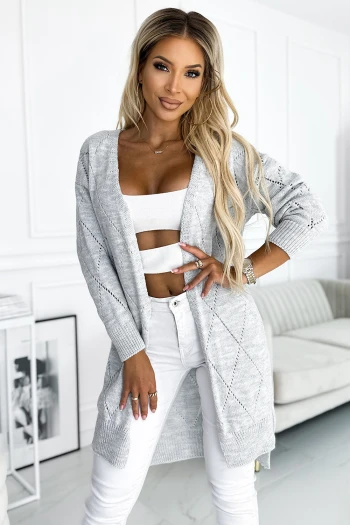The woman in the photo is wearing a stylish black and beige geometric print dress, perfect for a chic and modern look. This elegant geometric dress adds a touch of sophistication to any wardrobe.