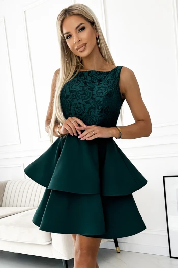 The woman in the photo is wearing a stunning green leaf print maxi dress, perfect for making a bold fashion statement. The model showcases the maxi dress with long sleeves and a flattering tie waist, ideal for both casual and formal occasions.
