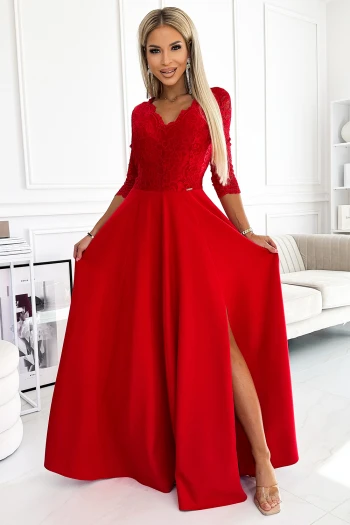 The woman in the photo is wearing a chic green backless dress, elegantly tied at the waist. This stylish dress showcases a sophisticated look perfect for any occasion.