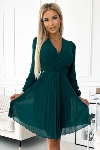 The woman in the photo is wearing a stunning gold satin gown, elegantly highlighting its luxurious fabric and flowing silhouette. The model showcases the dress's sophisticated design, perfect for formal occasions.
