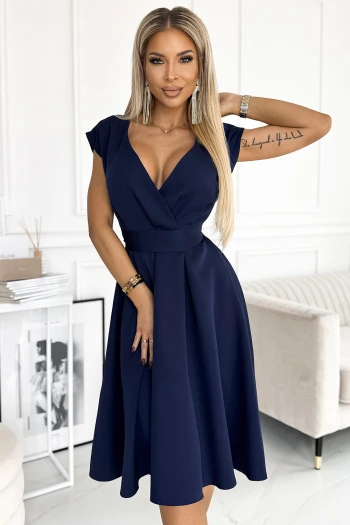 The woman in the photo is wearing a stylish green dress featuring elegant zipper details. This chic dress offers a perfect blend of comfort and sophistication for any occasion.