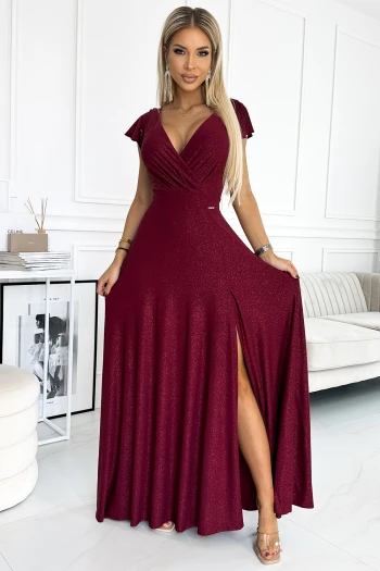 The woman in the photo is wearing a stylish navy wrap dress, elegantly tied at the waist. This chic wrap dress features long sleeves and a flattering V-neckline, perfect for any occasion.