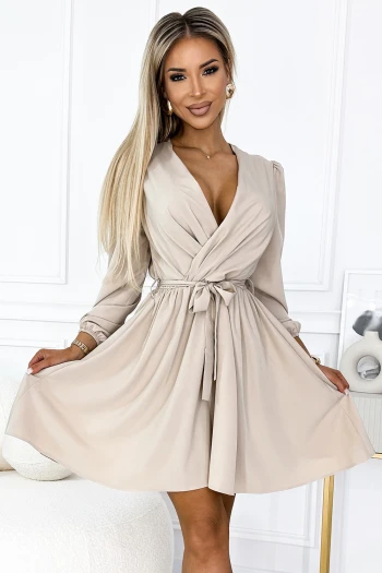 The woman in the photo is wearing a stunning floral maxi dress, featuring a black base adorned with vibrant pink and white blossoms. This elegant long dress is perfect for making a statement at any event.