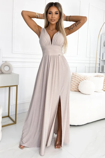 The woman in the photo is wearing a floral wrap dress, featuring a delicate pink and white pattern. This chic wrap dress elegantly highlights her style, perfect for any occasion.