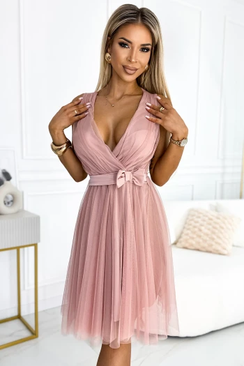 The woman in the photo is wearing a chic green ribbed dress, perfect for any elegant occasion. This stylish ribbed dress features a flattering fit that accentuates the silhouette beautifully.
