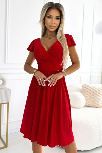 The woman in the photo is wearing a stylish beige wrap dress, featuring elegant long sleeves and a flattering V-neckline. This chic wrap dress is perfect for both casual outings and formal events, offering a versatile addition to any wardrobe.
