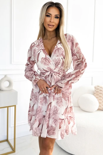 The woman in the photo is wearing a stylish beige shirt dress, featuring a belted waist for a flattering silhouette. This elegant shirt dress is perfect for both casual and formal occasions, showcasing timeless fashion.
