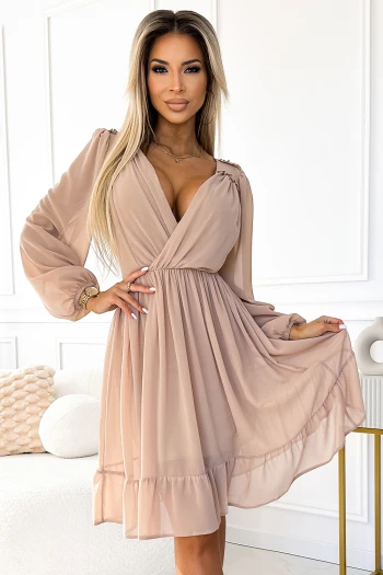 The woman in the photo is wearing a stylish pink mini dress, perfect for any casual outing. This chic dress features elegant sleeve details, making it a must-have addition to your wardrobe.