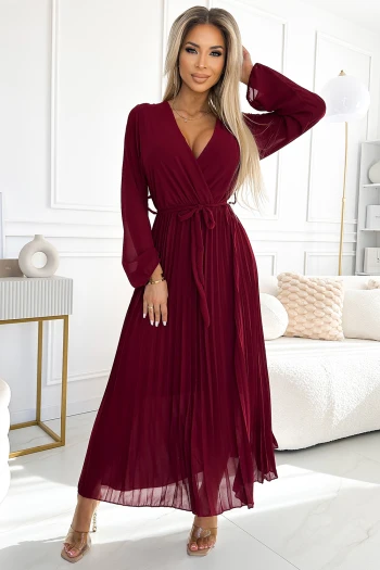 The woman in the photo is wearing a chic brown knit cardigan, elegantly paired with stylish tan leather leggings. This cozy ensemble highlights the versatility of the knit cardigan, perfect for a fashionable yet comfortable look.