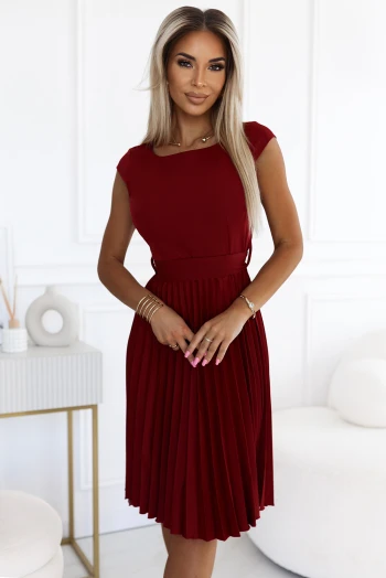 The woman in the photo is wearing a stylish floral dress, showcasing the vibrant patterns of the floral dress collection. The model highlights the elegant fit and intricate design of this floral dress, perfect for any occasion.