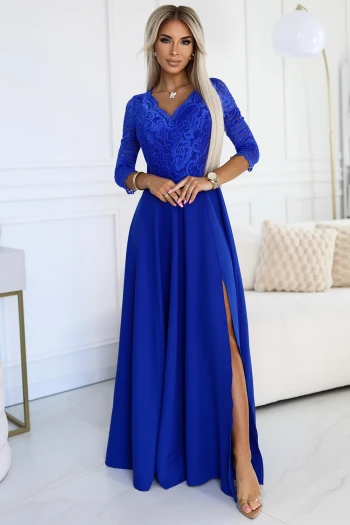 The woman in the photo is wearing a stunning emerald green glitter dress, perfect for evening events. The shimmering fabric of the green dress elegantly drapes, highlighting its luxurious texture.