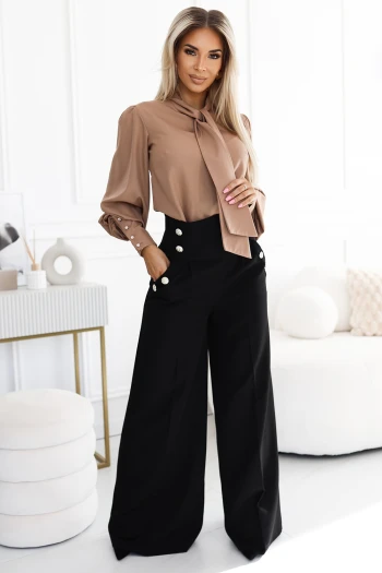 The woman in the photo is wearing an elegant satin one-shoulder dress adorned with intricate floral details. This stunning satin dress perfectly highlights the luxurious texture and sophisticated design.