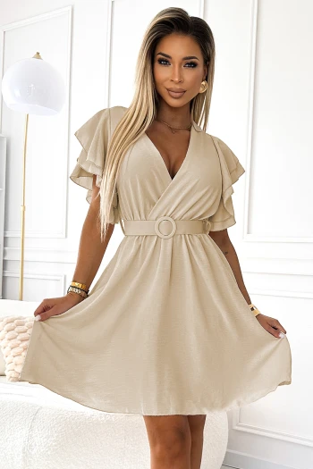 The woman in the photo is wearing a stunning silver evening gown with a deep V-neck and elegant draping. This glamorous dress is perfect for formal occasions, highlighting the sophistication of the silver gown.