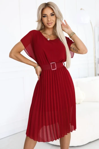 The model showcases a floral wrap dress adorned with a delicate pink and gray flower pattern. The dress features a stylish double-ring belt, adding an elegant touch to the floral wrap design.