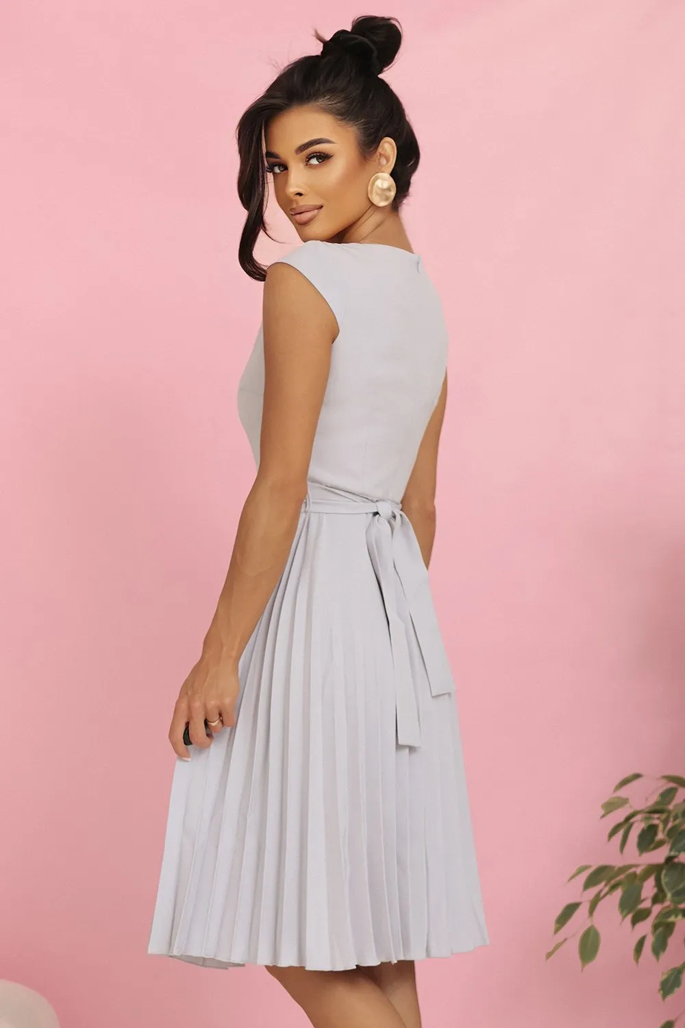 The woman in the photo is wearing a vibrant red bodycon dress, highlighting its sleek and elegant design. This stylish bodycon dress is perfect for making a bold fashion statement.
