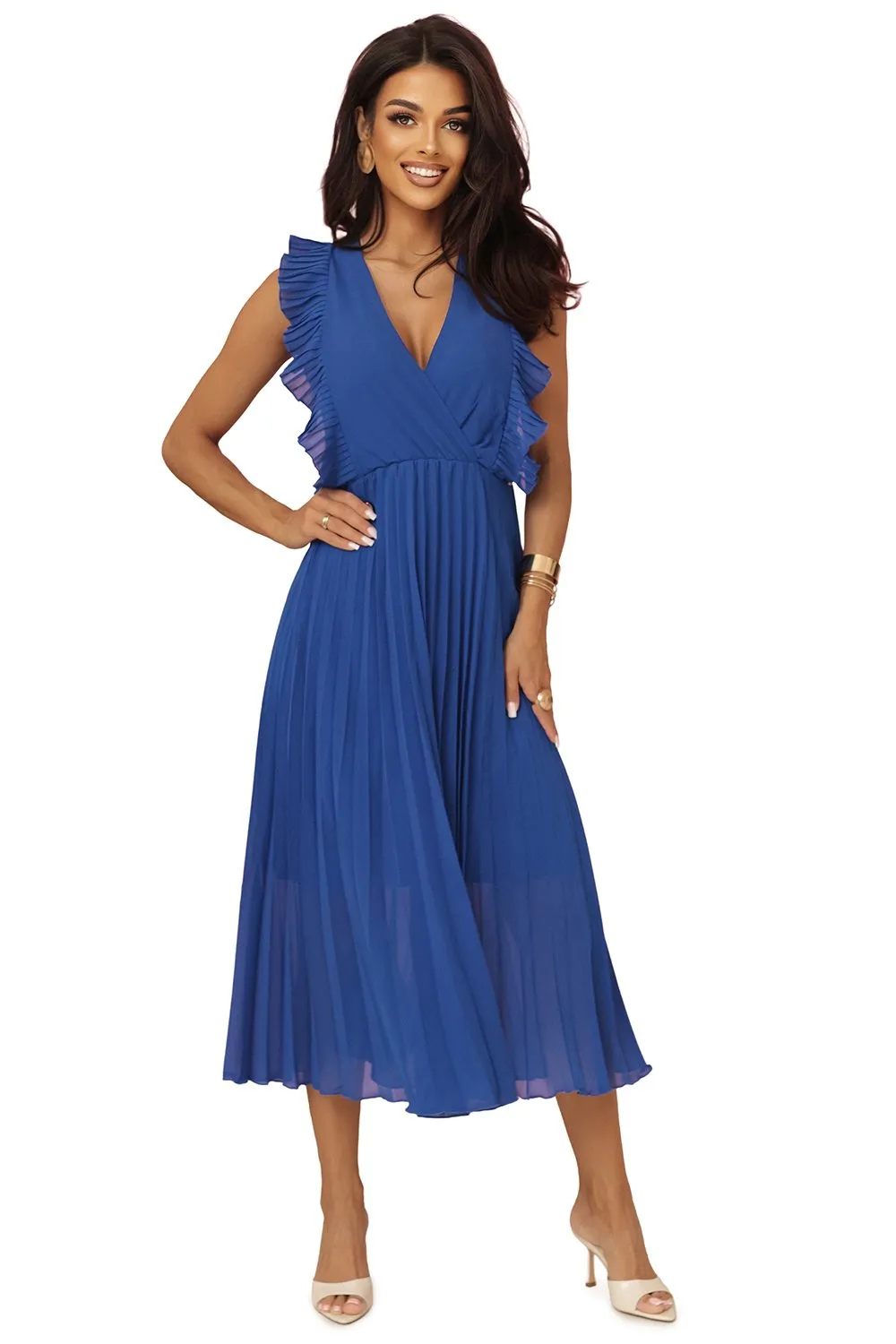 The woman in the photo is wearing a sleek black midi dress, elegantly tied at the waist for a flattering silhouette. This stylish black dress is perfect for both casual and formal occasions, showcasing timeless fashion.
