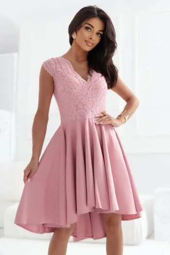 The woman in the photo is wearing a stylish brown bodycon dress, highlighting its elegant fit and intricate lace detailing. This bodycon dress is perfect for showcasing a sophisticated and chic look.