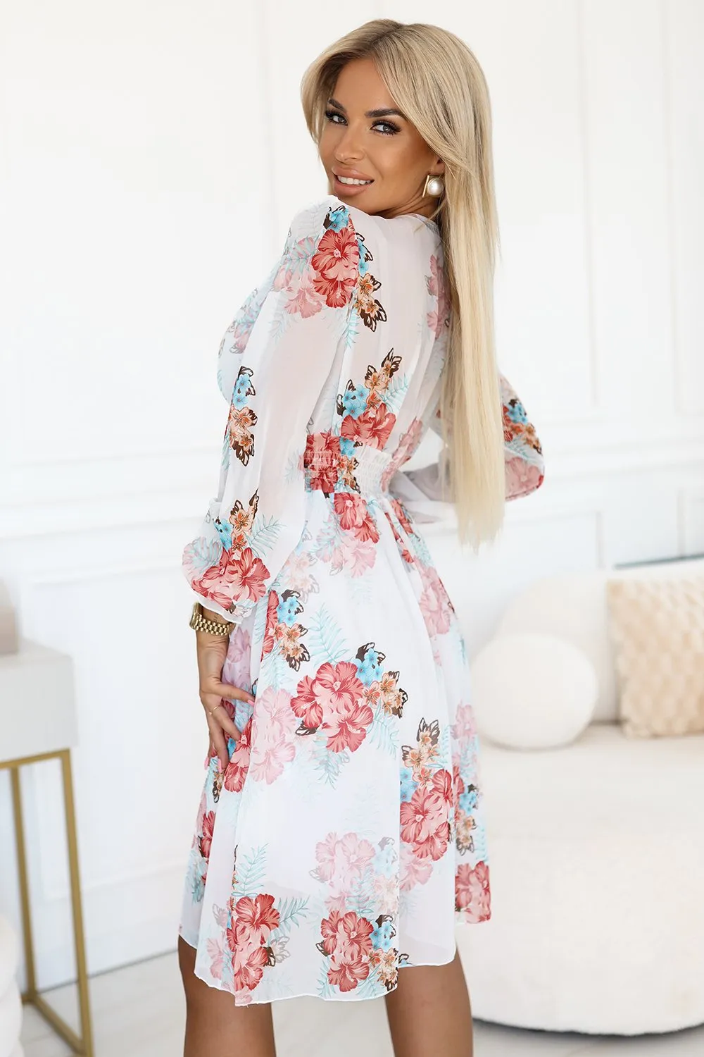 The woman in the photo is wearing a stylish mint green skirt set, featuring a long-sleeve top and a knee-length skirt. This elegant ensemble showcases the perfect blend of comfort and fashion, ideal for any occasion.