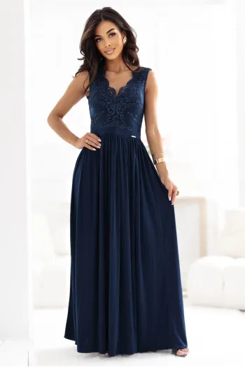 The woman in the photo is wearing a stunning floral maxi dress, perfect for elegant occasions. The model showcases the dress's vibrant pattern and flowing silhouette, highlighting its sophisticated charm.