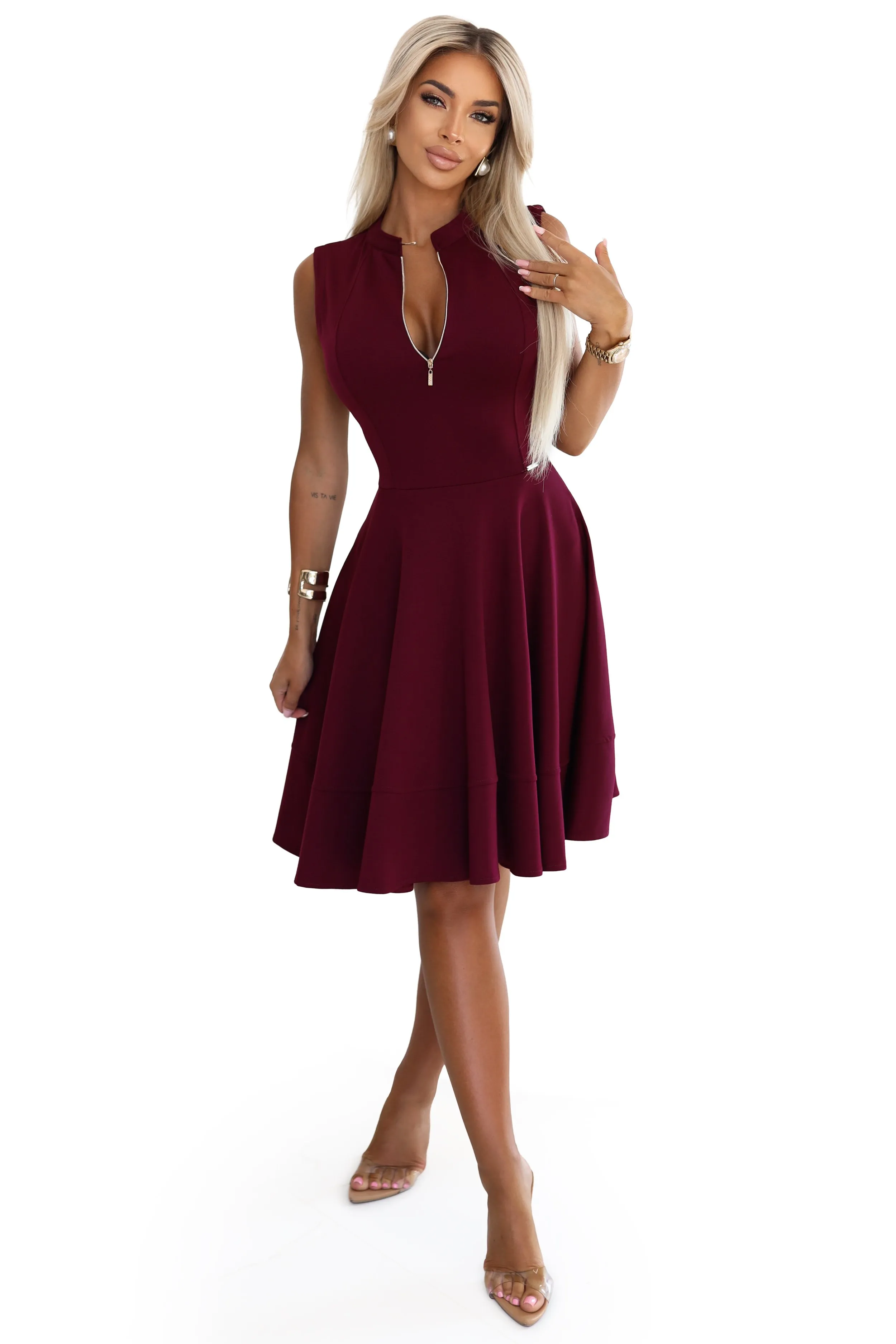 The woman in the photo is wearing a stylish green dress, perfect for casual outings. This chic outfit features a belted waist, highlighting the dress's elegant design.