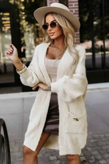 The woman in the photo is wearing a stylish black fringe jacket, paired with high-waisted leather pants, creating a chic and modern look. This fringe jacket adds a touch of edgy sophistication, perfect for making a fashion statement.