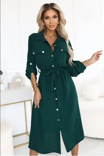 The woman in the photo is wearing a stylish green shirt dress, complete with a tie waist and button detailing. This elegant shirt dress is perfect for elevating any wardrobe with its versatile design.