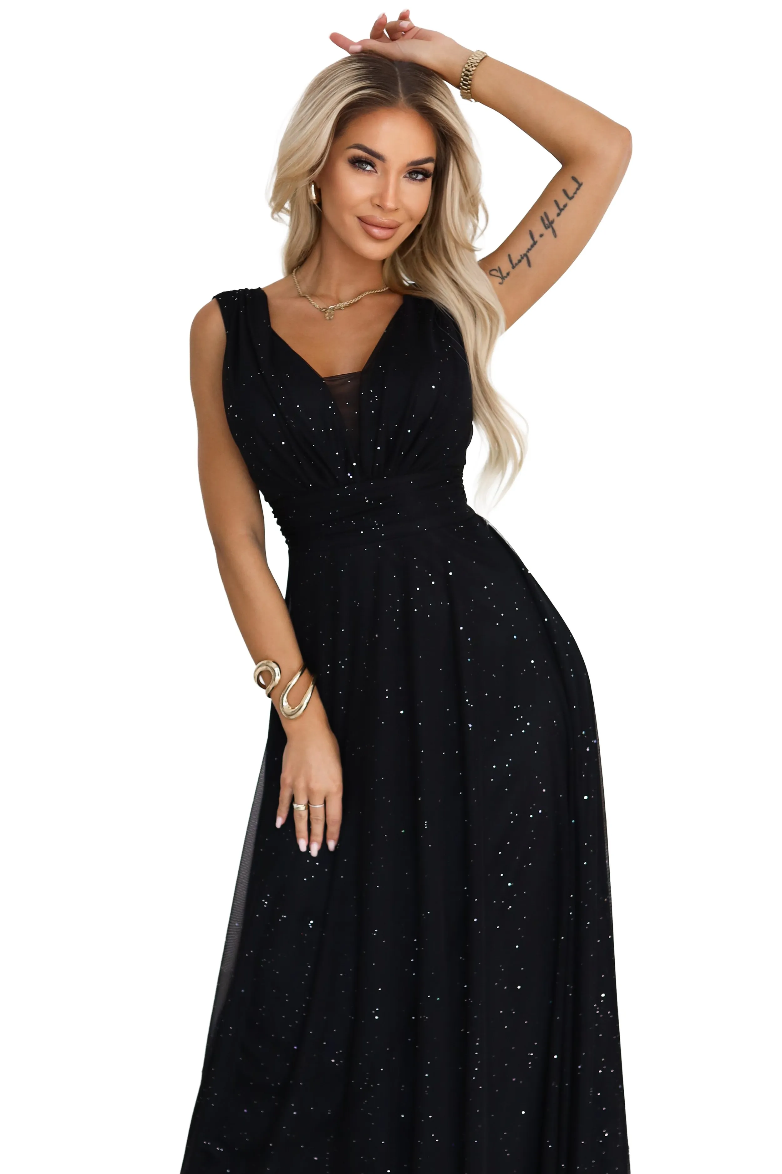 The model showcases a stunning evening gown featuring an elegant black design adorned with delicate sparkles. This long black dress exudes sophistication, perfect for formal events.